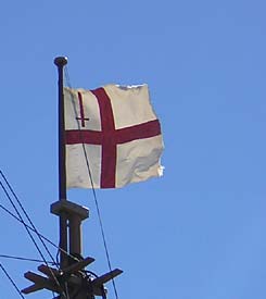 The flag flying from the mast of the Mayflower II in Plymouth, MA